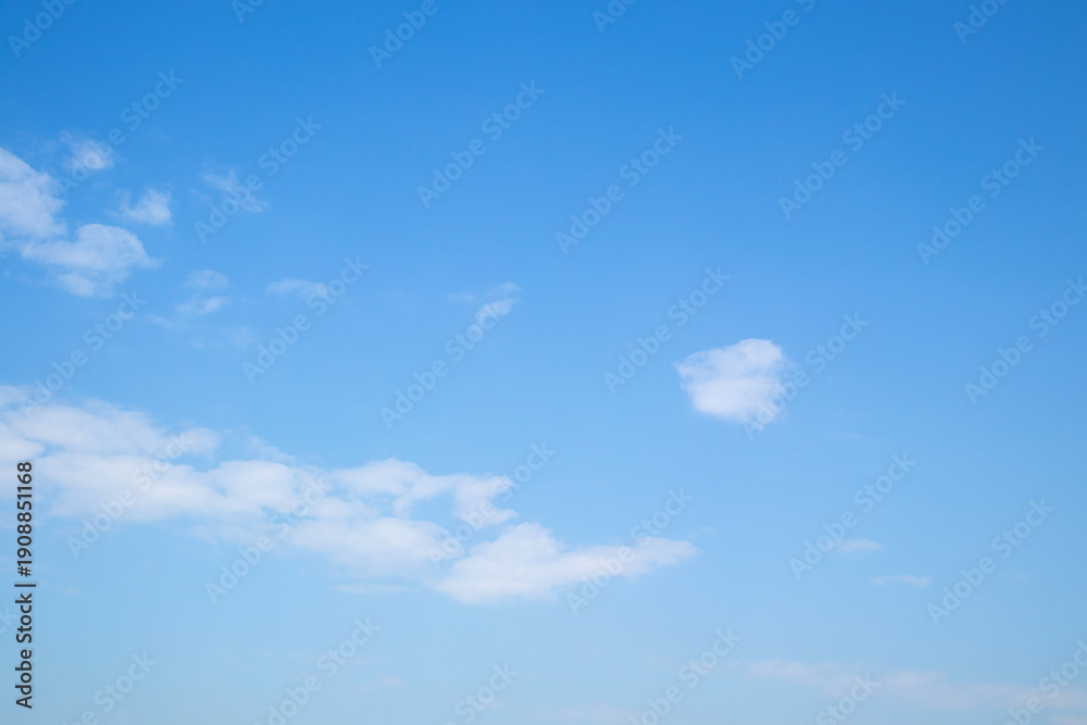 Fototapeta premium Beautiful blue sky with white clouds on a sunny day background