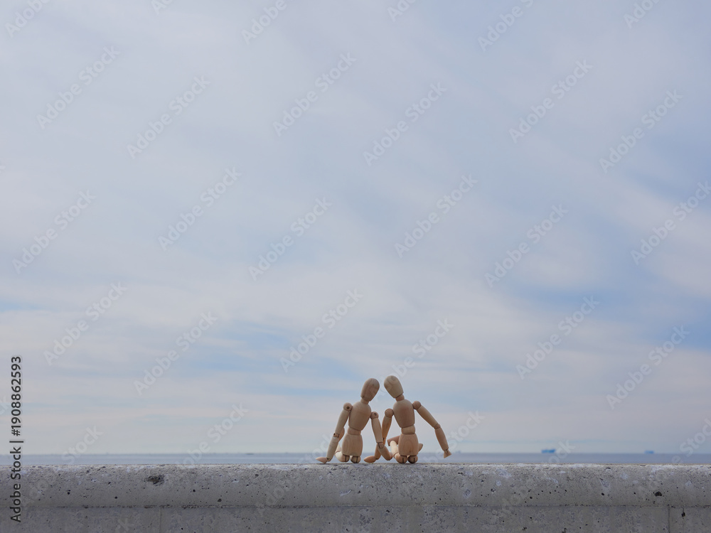 custom made wallpaper toronto digital冬の空と海岸の堤防に座る二人の木製のマネキン人形の姿