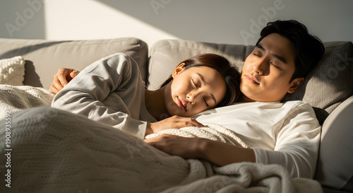 East Asian couple sleeping peacefully together on a comfortable
