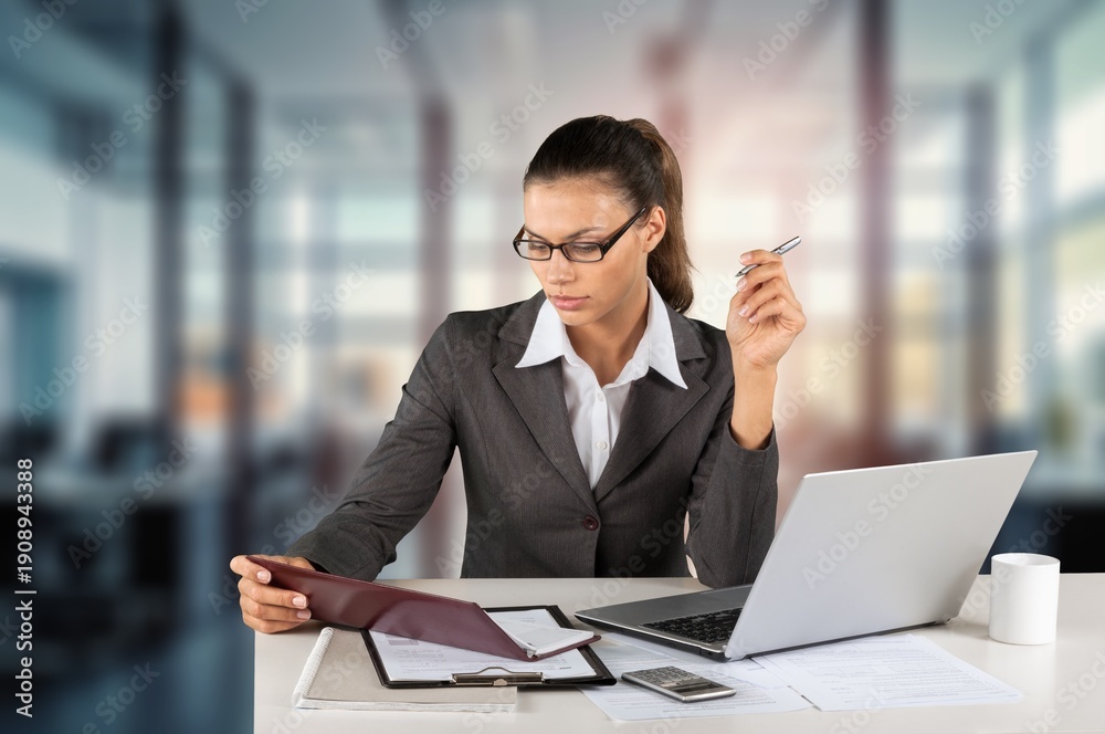 Fototapeta premium Focused young business worker working on laptop