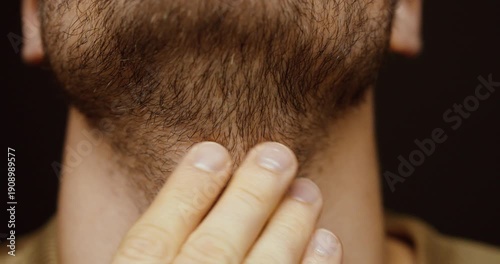 Close-up of a man’s unshaved beard and neck without clean contours. Concept of grooming, personal care, beard growth, masculinity, and everyday appearance.