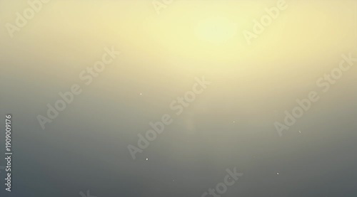 Subtle gradient background from yellowish to dark gray with blurred dust particles
