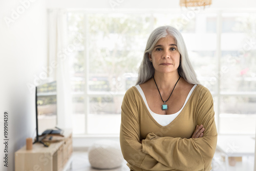 Φωτογραφία Middle-aged woman dressed in casual outfit with long grey hair, standing confide