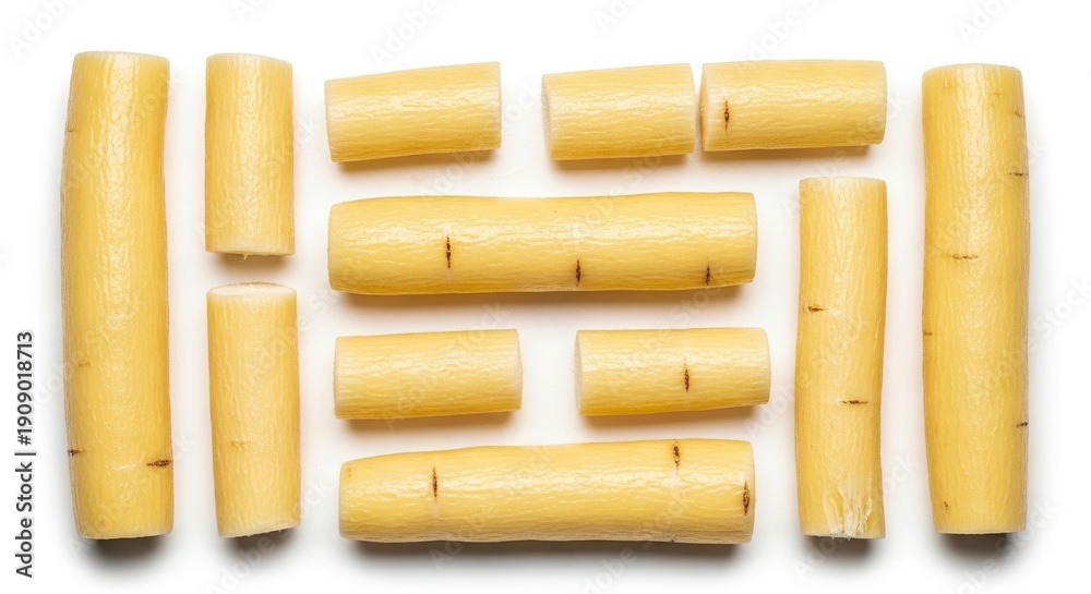 Fototapeta premium Arranged pale yellow cassava root segments on white