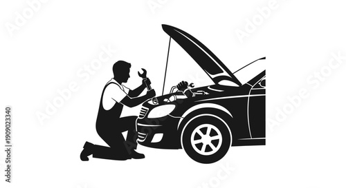 Mechanic kneeling beside car engine.