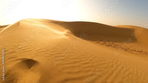 Beautiful Rippling Golden Sand Dunes Under Bright Desert Sky