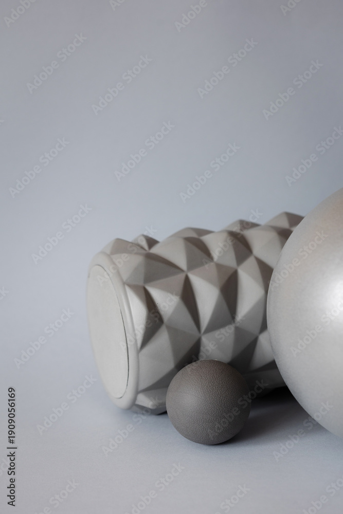 Fototapeta premium gray solid background for sports and fitness with copy space. mfr roll and massage ball for training