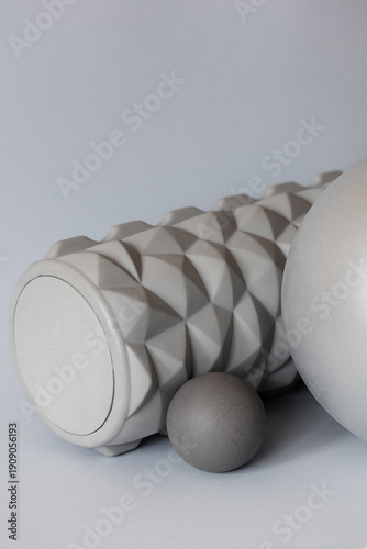 gray solid background for sports and fitness with copy space. mfr roll and massage ball for training