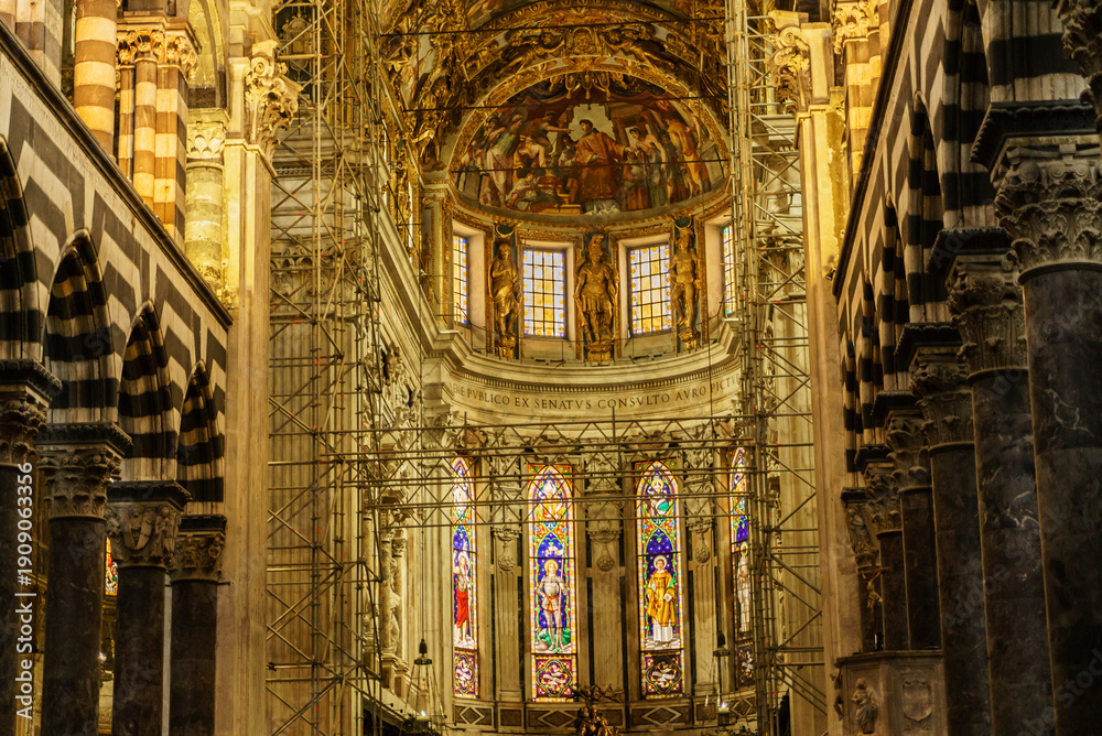 Fototapeta premium Workers restore the grand interior of an ancient cathedral, revealing stunning stained glass