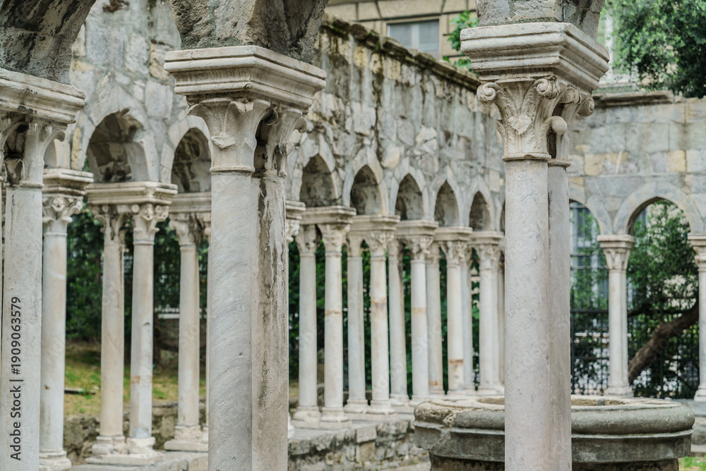 Fototapeta premium Columns rise gracefully in a tranquil courtyard, surrounded by nature, evoking a sense of serenity