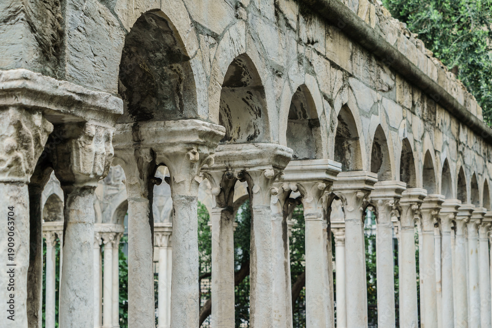 Fototapeta premium Stone columns support elegant arches, inviting exploration through beautiful, overgrown ruins