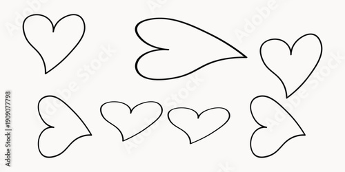 A collection of hand drawn hearts floating in the air with varying sizes and orientations