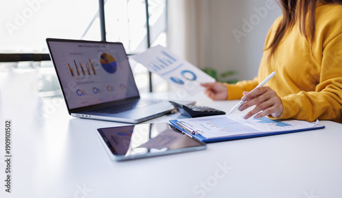 Photography Cusiness woman thinking, calculating, looking at financial statements and planning marketing, reviewing documents, calculating numbers, recording data on laptop online in office