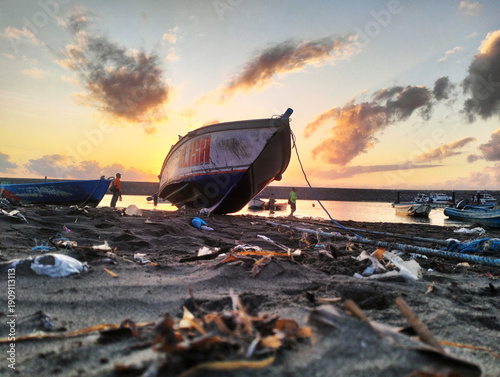 small boat moored on the shore
