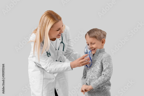 Cute little boy with doctor...
