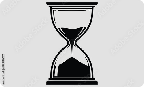 Hourglass with black sand on a gray background