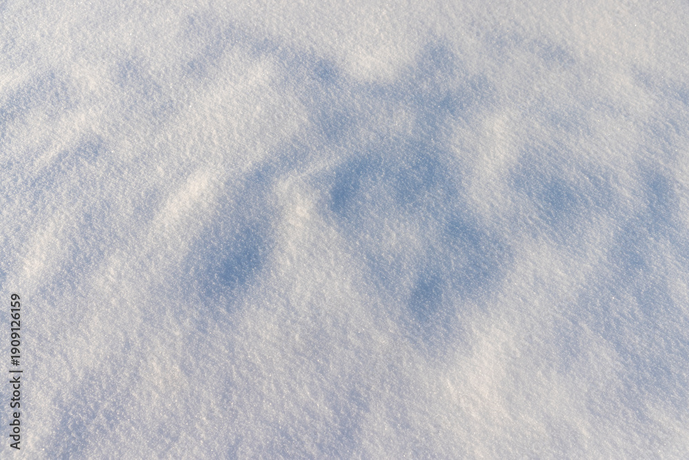 Obraz premium large deep fresh snowdrifts of white color in the field during the winter season, large soft snowdrifts after large snowfalls in sunny weather, snow structure