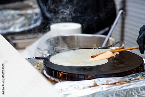 Quadro em tela Cooking pancakes outdoors in a close-up with rising steam, which is timed to coincide with the arrival of spring and the Maslenitsa holiday