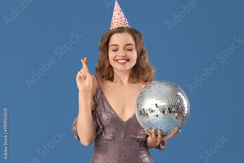 Young woman in party hat wi...