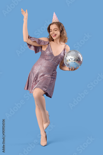 Young woman in party hat wi...