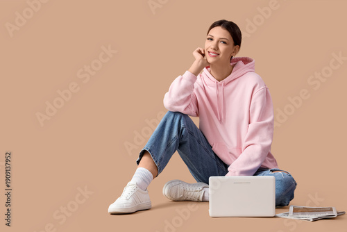 Young woman with laptop and...
