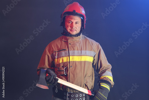 Male firefighter with axe i...