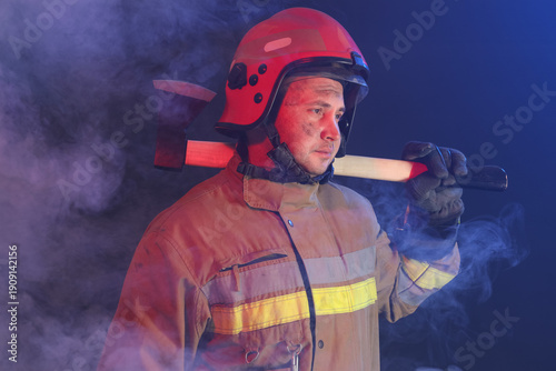 Male firefighter with axe i...