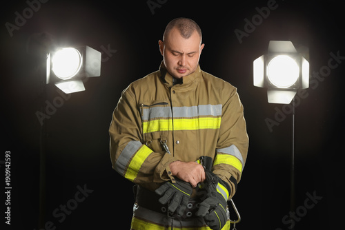 Male firefighter putting gl...