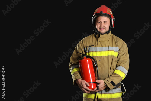 Male firefighter with extin...