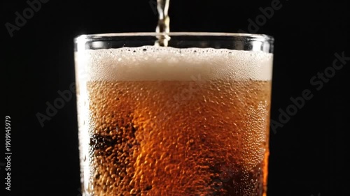 Wallpaper Mural Close up view of dark carbonated beverage being poured into a clear glass, creating foam and bubbles with a dark background Torontodigital.ca