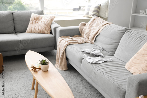 Swimsuit on grey sofa in li...