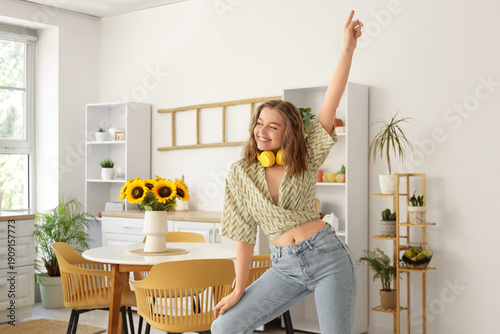 Cool young woman dancing in...