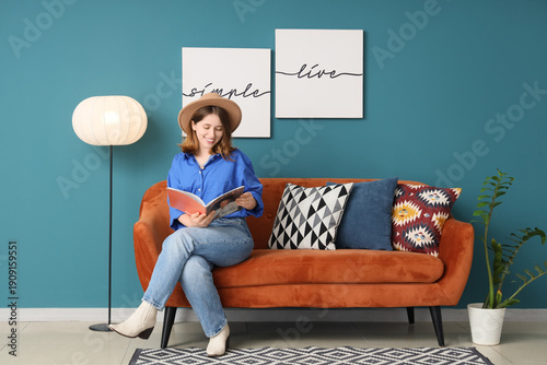 Young woman reading magazin...