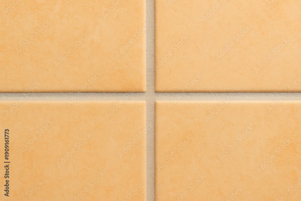 Fototapeta premium Close-up of ceramic floor tiles in warm neutral tones, showcasing the texture and grout lines, ideal for backgrounds and design elements in interior projects.