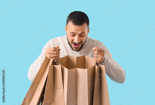 Happy young man with paper ...