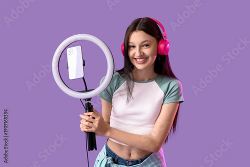 Teenage blogger in headphon...