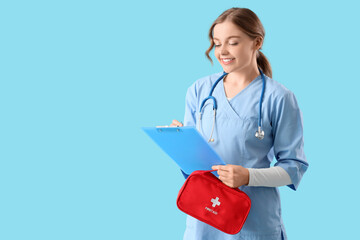 Female doctor with first aid kit and clipboard on blue background