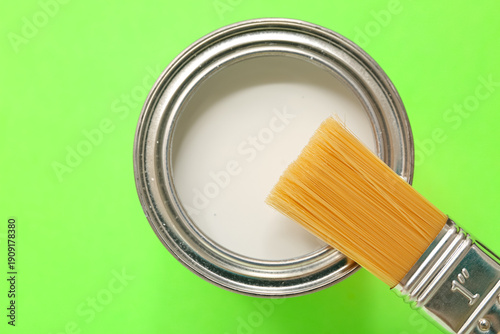 Can of white paint and brus...