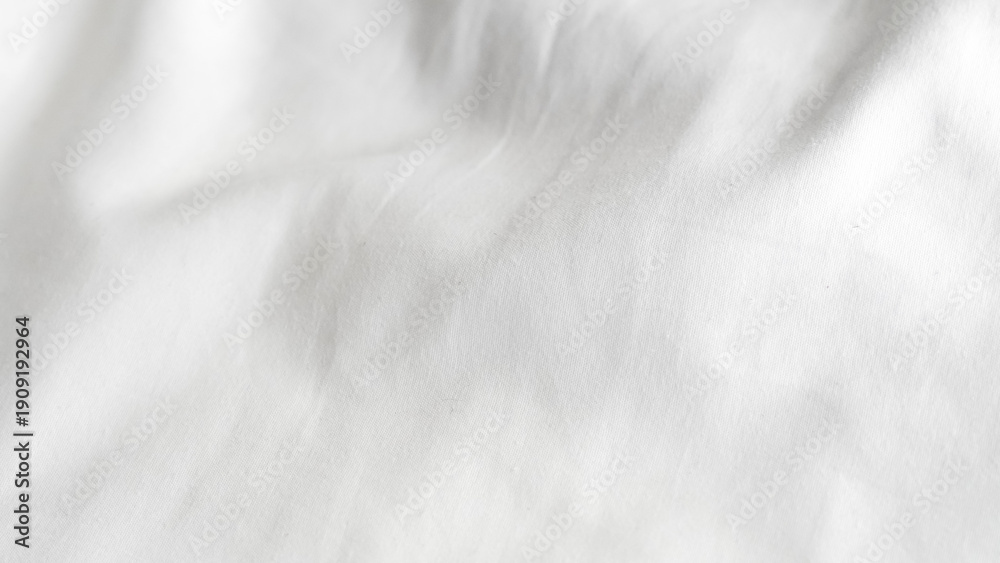 Obraz premium Close-up of textured white fabric with soft folds and creases
