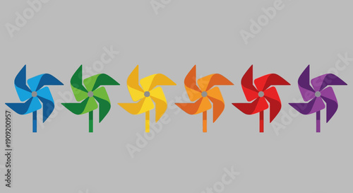 Colorful pinwheels arranged in a rainbow sequence on a gray background.