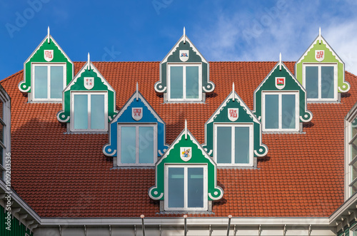 Colorful windows on the roof of the new town hall in Zaandam, the Netherlands, against a blue sky. Typical traditional Dutch architecture.