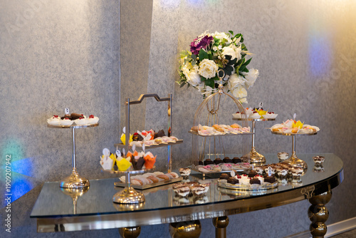 Colourful candy bar with assorted homemade cookies and sweet treats in various flavours and vibrant colours. 