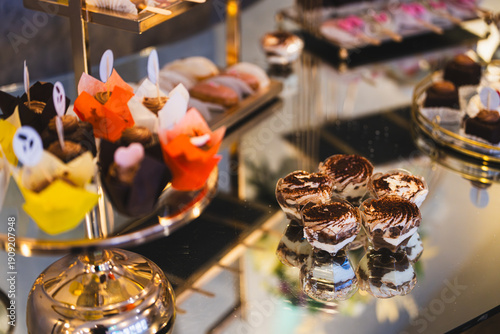 Colourful candy bar with assorted homemade cookies and sweet treats in various flavours and vibrant colours. 