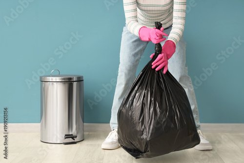Woman with garbage bag and ...