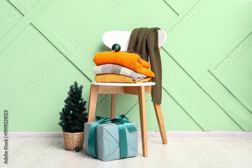 Stacked clothes on chair wi...
