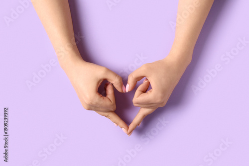 Woman making heart with her...