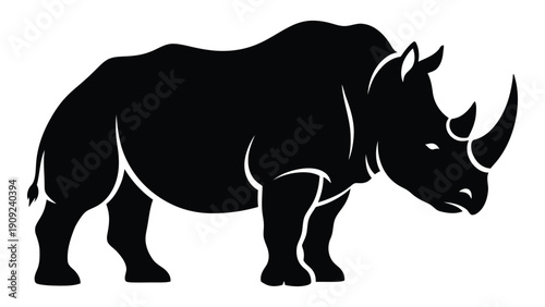 A powerful black silhouette of a rhinoceros standing on a white background isolated on white background, Vector