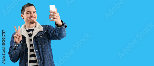 Cool young man with smartph...