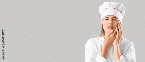 Young female chef suffering...