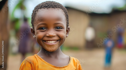 Little smiling African child from slums on blurred background of poor African school, children in background, cheerful kid in tribal village, diversity, volunteer help, education in Africa